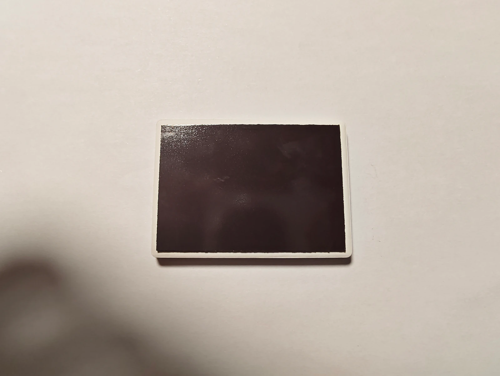 Back of the real ceramic Qiqi keepsake showing the full rectangular magnetic backing.